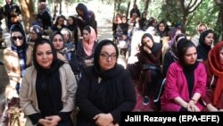 Afghan women attending an event to launch the My Red Line campaign in Herat on August 1.