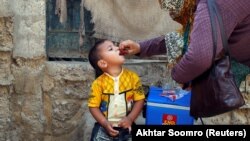 A boy receives polio vaccine drops during an antipolio campaign in Karachi in April.