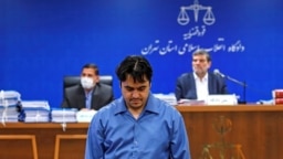 Ruhollah Zam at his trial in Tehran earlier this year. 