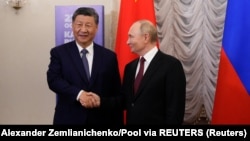 Russian President Vladimir Putin shakes hands with Chinese President Xi Jinping during a meeting on the sidelines of the BRICS Summit in Kazan, Russia October 22, 2024. 