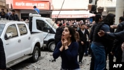 A woman reacts at the site of a blast near the riot police headquarters in the center of Diyarbakir on April 11.