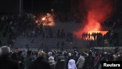 Soccer fans flee from violence at Port Said's stadium on February 1.