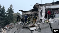 Rescuers conduct search and rescue operations following a Russian attack that struck a five-story residential building in Zaporizhzhia on October 10, killing at least five people. 