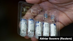 A paramedic holds a pack of used and unused vials of Russia's Sputnik V COVID-19 vaccine. (file photo)
