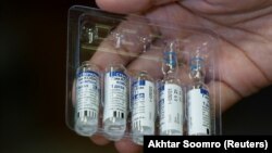 A paramedic holds a pack of used and unused vials of Russia's Sputnik V COVID-19 vaccine. (file photo)