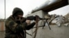 A militant fighting for Russia-backed separatist forces aims his weapon near the town of Avdiyivka, outside Donetsk,.