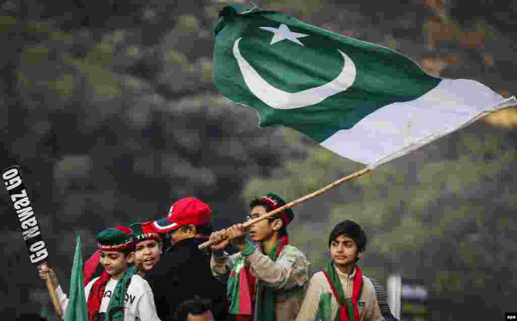 Supporters of Imran Khan, the head of opposition political party Pakistan Tehrik-e-Insaf, wave the national flag during a protest against the ruling party Pakistan Muslim League Nawaz in Lahore. (EPA/Omer Saleem)