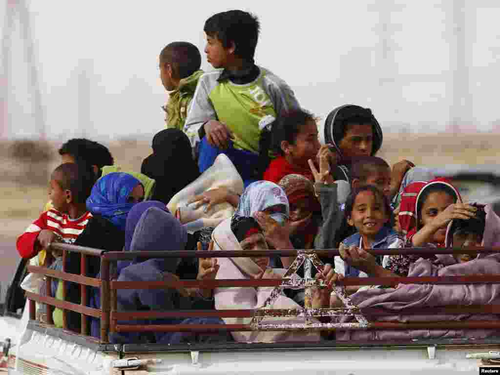 A family flees toward Benghazi as rebels retreat from towns west of Ajdabiya on March 30. Photo by Andrew Winning for Reuters