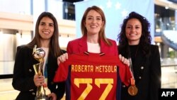 Roberta Metsola, az Európai Parlament elnöke mezt kap a spanyol női válogatott tagjaitól, Ivana Andréstől (b) és Alba Redondótól 2024. március 12-én