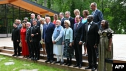 Members of the G7 -- including US President Donald Trump (center) -- pose for a photo during a summit held in Evian Evian-les-Bains, France, on June 16.