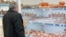 Armenia -- A man looks at meat products at a food store in Yerevan.
