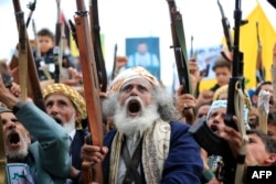 Supporters of the Iran-backed Houthi movement brandish their weapons as they rally in the Yemeni capital, Sanaa, in solidarity with Iran and Lebanon amid the Middle East conflict. (file photo)