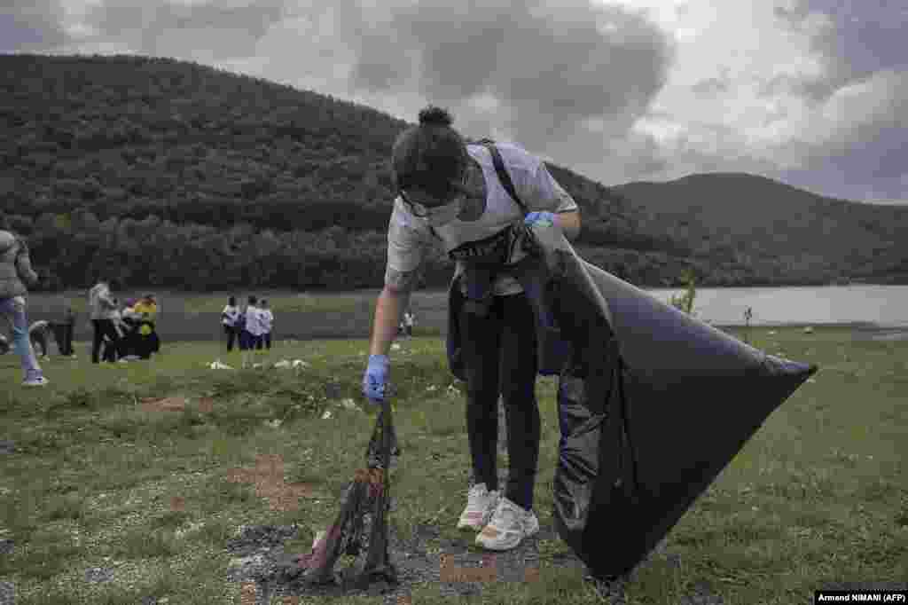 Volunteers clean up the banks of Badovac Lake during an operation to mark World Cleanup Day in Badovce, near Pristina, on September 20.