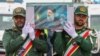 This handout picture provided by the Iranian president's office shows honour guards carrying the coffin of late president Ebrahim Raisi during a funeral procession in Tabriz, the capital of Iran's East Azerbaijan province, on May 21, 2024 for him and seve