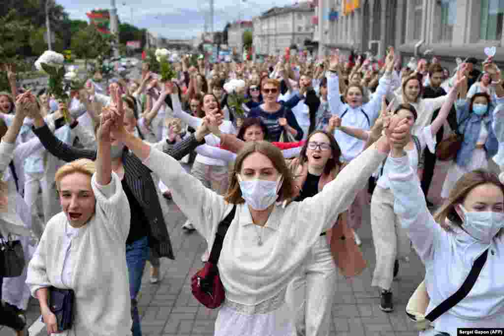 Women take part in a demonstration against police violence against protesters in Minsk on August 12.