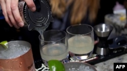 A bartender fills glasses at a promotional event in Chicago in May of Russian Standard Vodka, which is targeted along with Stolichnaya by the U.S.-based boycott to protest Russia's antigay legislation.