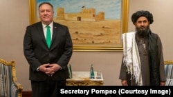 U.S. Secretary of State Mike Pompeo and Mullah Abdul Ghani Baradar, a co-founder of the Taliban and a former deputy to Mullah Omar. Baradar, who spent years in a Pakistani prison, is the Taliban’s political chief and was the head negotiator in talks with the United States.