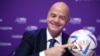 (FILES) FIFA president Gianni Infantino poses with Al Rihla, the official match ball before a press conference during the 72nd FIFA Congress in the Qatari capital Doha, on March 31, 2022.