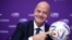 (FILES) FIFA president Gianni Infantino poses with Al Rihla, the official match ball before a press conference during the 72nd FIFA Congress in the Qatari capital Doha, on March 31, 2022.