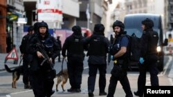 Police converge near the site of a deadly knife attack at London Bridge in the British capital on November 29.