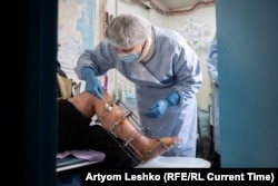 Irina Safonova attends to a patient who injured his leg in an accident at a construction site.