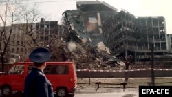 A member of a Russian delegation visiting Belgrade in April 1999 looks at the building of the Serbian Interior Ministry which was totally destroyed in overnight NATO bombing.