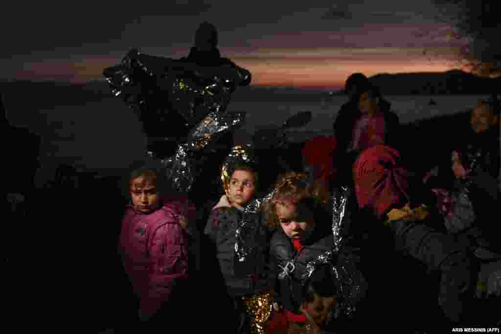 Migrant children wait near Skala Sykamineas on the Greek island of Lesbos after crossing the Aegean sea between Turkey and Greece on March 1.