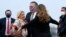 U.S. Secretary of State Mike Pompeo (center), and his wife, Susan (right), embrace U.S. Ambassador to France Jamie McCourt (left) after stepping off a plane in Paris on November 14.