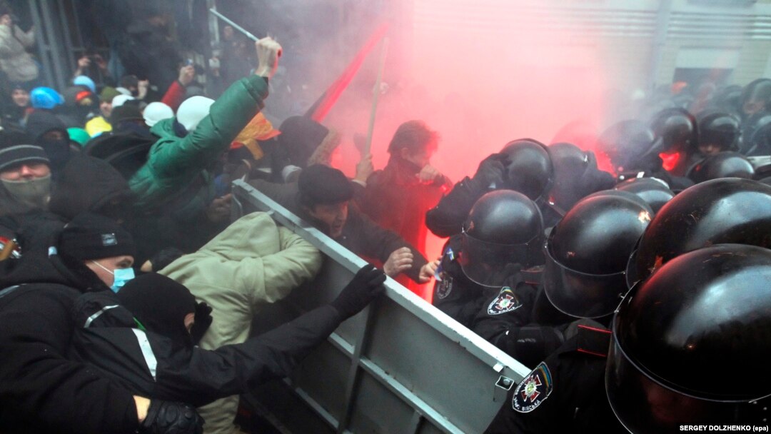 Protesters try to break through a riot police line near the presidential administration building during a rally by EU supporters in Kyiv on December 1. 