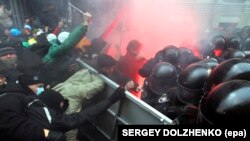 Protesters try to break through a riot police line near the presidential administration building during a rally by EU supporters in Kyiv on December 1. 