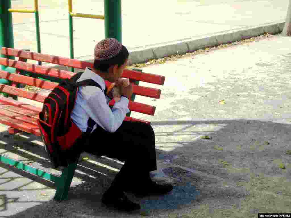 Aşgabatda okuwdan gelýän bir okuwçy oglan awtobusa garaşýar.