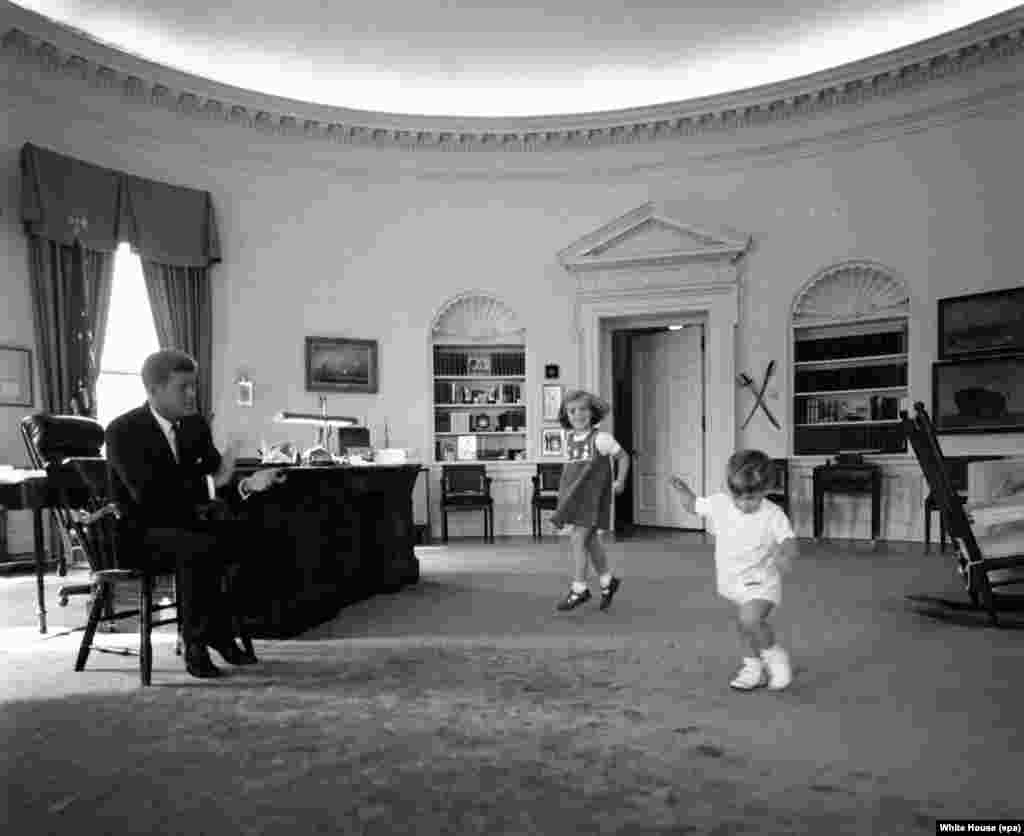 President Kennedy with daughter Caroline and son John Jr. in the Oval Office of the White House on October 10, 1962.