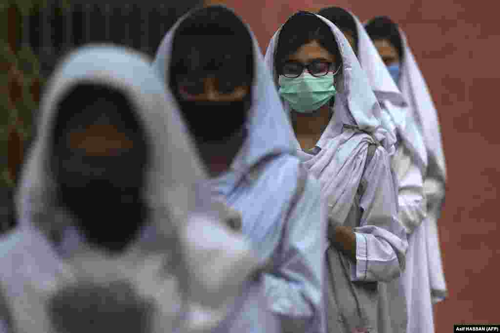 Students wearing face masks take part in an assembly at a school in Karachi, Pakistan.