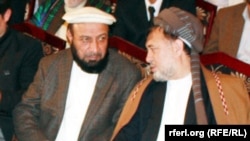 Mohammad Khan (left) and Mohammad Mohaqiq talk during a gathering in Kabul in May 2014.