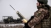 Soldiers of Ukraine's 24th Separate Mechanized Brigade fire a BM-21 Grad multiple-rocket launcher toward Russian troops near the frontline town of Chasiv Yar in the Donetsk region on January 15.