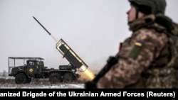 Soldiers of Ukraine's 24th Separate Mechanized Brigade fire a BM-21 Grad multiple-rocket launcher toward Russian troops near the frontline town of Chasiv Yar in the Donetsk region on January 15.