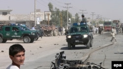 Wreckage after the earlier attack on the security firm in Kandahar