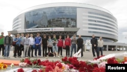 Mourners place flowers at the hockey arena in Minsk that was to have been the site of the team's season-opening game on September 9.