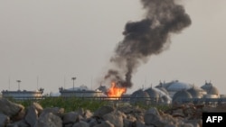 Flames burn at a facility belonging to Saudi oil giant Aramco south of Riyadh on October 3.