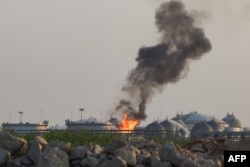 Flames burn at a facility belonging to Saudi oil giant Aramco south of Riyadh on October 3.
