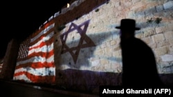 The Israeli and U.S. flags are projected onto the walls of the ramparts of Jerusalem's Old City, to mark one year since the transfer of the U.S. Embassy from Tel Aviv to Jerusalem.