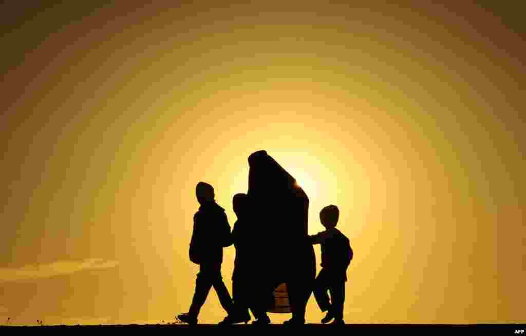 An Afghan family during sunset in Herat. (AFP/Aref Karimi)