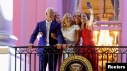 U.S. President Joe Biden (in front, from left), First Lady Jill Biden, their daughter, Ashley Biden, and granddaughters Finnegan and Naomi pose for a picture during a celebration of Independence Day in Washington on July 4, 2021.