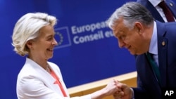 European Commission President Ursula von der Leyen (left) is greeted by Hungarian Prime Minister Viktor Orban during a meeting at the EU summit in Brussels on June 17.