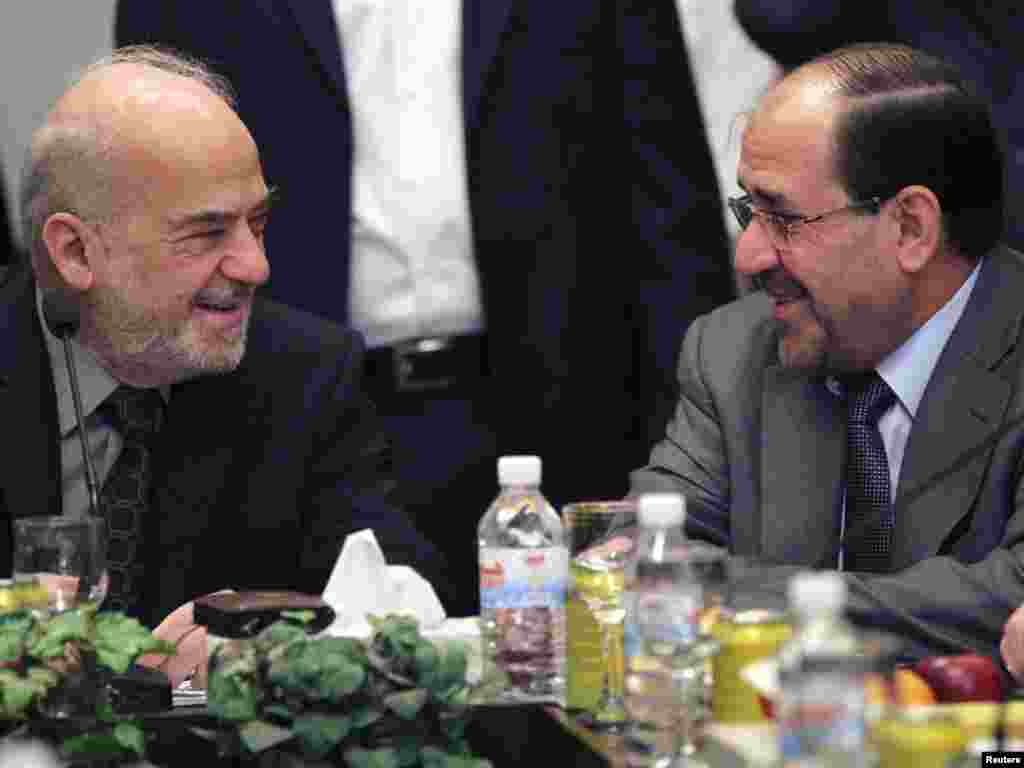 Iraq -- Prime Minister Nuri al-Maliki (R) speaks with the head of Current National Reform Ibrahim al-Jaafari during a meeting for the National Alliance in Baghdad, 25Oct2010 - Iraq's Prime Minister Nuri al-Maliki (R) speaks with former prime minister and the head of Current National Reform Ibrahim al-Jaafari during a meeting for the National Alliance in Baghdad October 25, 2010. The pace of coalition talks in Iraq may speed up after a court told parliament to convene and political blocs agreed to meet, putting pressure on the Kurds to pick a winning side seven months after an inconclusive election. Picture taken October 25, 2010. REUTERS/Mohammed Ameen (IRAQ - Tags: POLITICS)