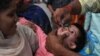 A Pakistani health worker administers polio drops to a child at a railway station during a polio vaccination campaign in Lahore on November 5.