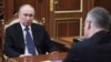 Russian President Vladimir Putin meets a Russian regional official at the Kremlin, July 28, 2025.