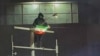 Iran - a protester holds a flag during ongoing protests in Tehran on January 9 - screen grab