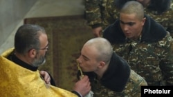 Armenia - Soldiers kiss a cross during a church service, February 6, 2016.