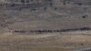 SYRIA -- People start to walk away from the border fence between Israel and Syria at its Syrian side as it is seen from the Israeli-occupied Golan Heights near the Israeli Syrian border July 17, 2018